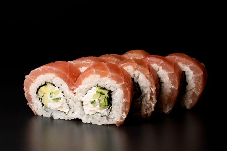 delicious Philadelphia sushi rolls with salmon, cucumber, avocado, cream cheese. On dark background.の写真素材