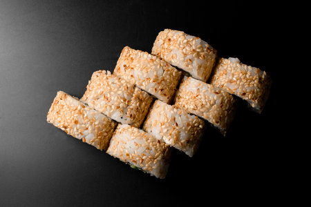 top view on sushi rolls california with decorated with sesame seeds on dark background.の写真素材