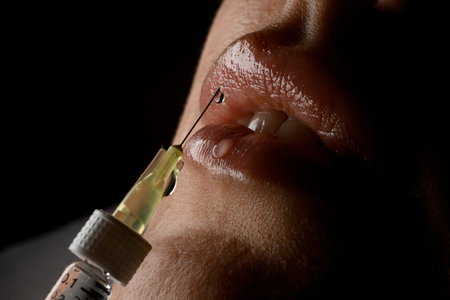 Close up of cosmetic botox injection in female lips. Woman having injectionの写真素材