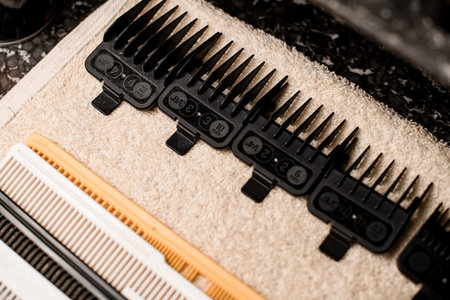 close-up top view of attachments for a hair clipper. Cropped photo. Barbershopの写真素材