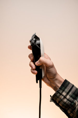 side view of electric hair clipper in male hand.の写真素材