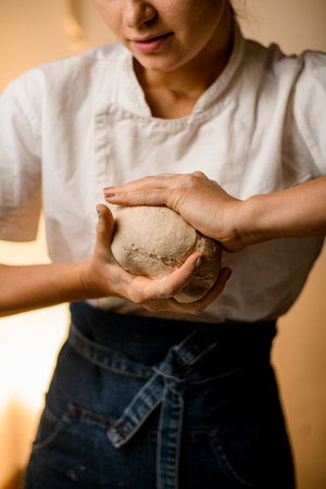 female baker hands kneading dough for homemade bread cooking. Bakery conceptの写真素材