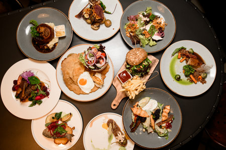 top view of plates with different dishes on tableの写真素材