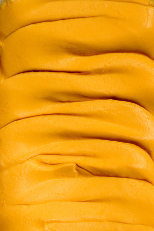 Apricot sweet ganache or cream for covering and decorating cakes, macarons and desserts