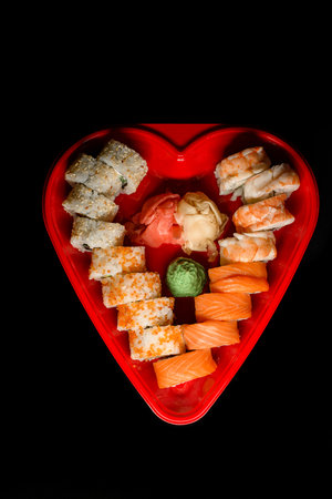 Heart shaped sushi box. Sushi rolls philadelphia and california set for two for dating dinnerの写真素材