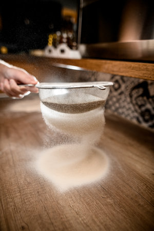 Chef sowing flour, preparing for the dough kneading processの写真素材