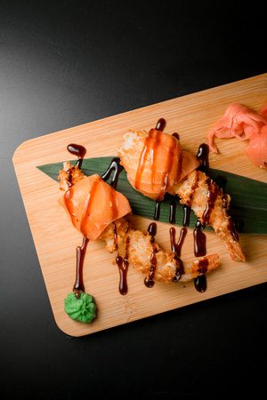 Pieces of a red fish on a board with hot spices on a dark backgroundの写真素材