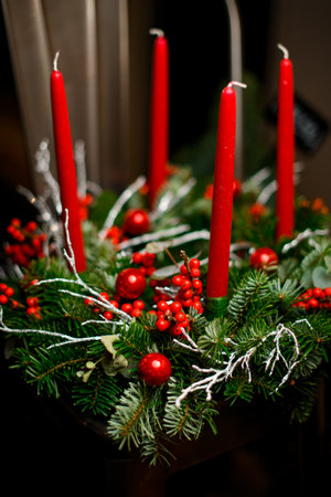 Christmas tree wreath decorated with four red candles isolatedの写真素材