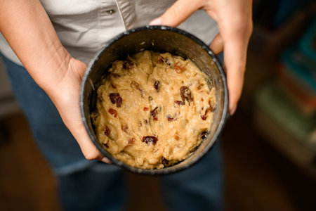 Appetizing pie inside a baking dish, filled with nuts, raisins, candied fruits
