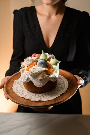 Cake with delicious cream and almond filling on a wooden stand