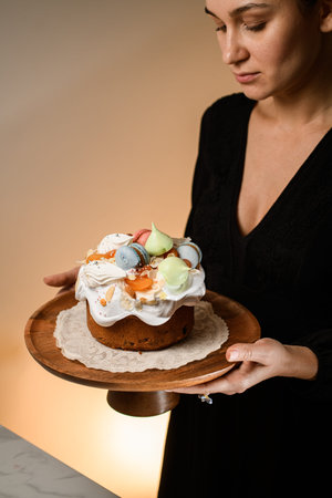 Girl in a black dress holding a delicious creamy cupcakeの写真素材