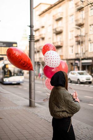 Dark hair girl in a grey jacket with a black hoodの写真素材