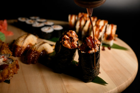 Focus on two shrimp stuffed buns covered with brown sauce from a bottleの写真素材