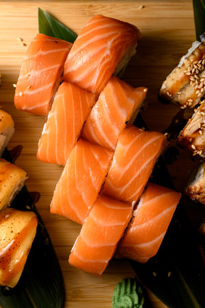 Top view of philadelphia salmon sushi rolls between two other types of sushi rollsの写真素材