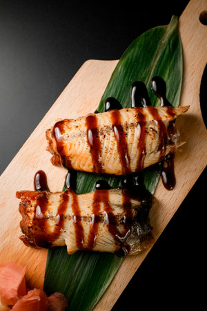 Eel with teriyaki on a leaf with ginger and wasabiの写真素材