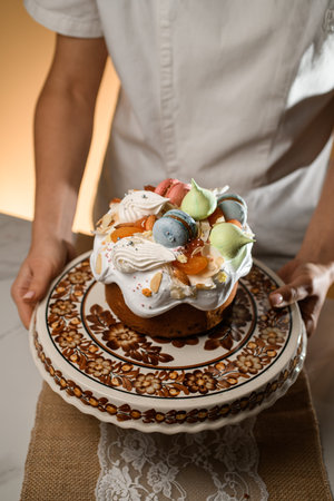 Beautifully decorated Easter cake stands on a stand with an ornament