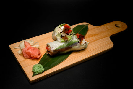 Japanese shawarma on wooden board with banana leaf, ginger, and wasabi.