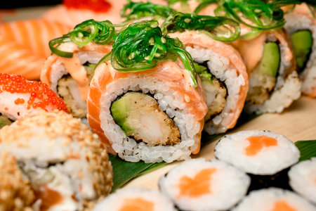 Salmon rolls seasoned with nori in a diverse sushi set.の写真素材