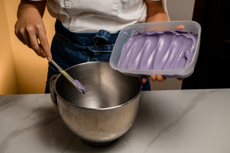 Metal bowl and delicious lavender cream in plastic container