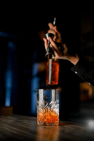 Alcohol cocktail maker make a alcohol cocktail with rum and ice on a bar counterの写真素材