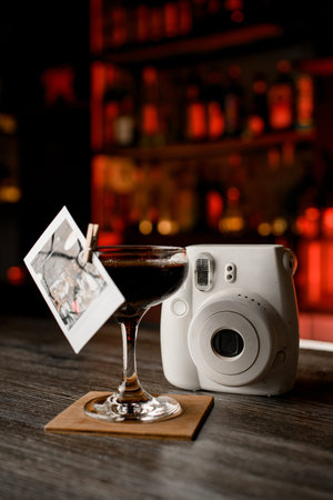 Nostalgic Blend. Cocktail evokes old memories with an antique camera and snapshot.