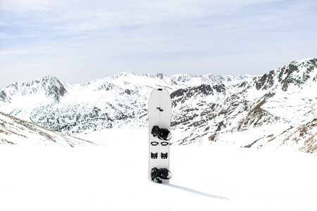 White skiers splitboard is stuck in the snow against the background of mountain peaksの写真素材