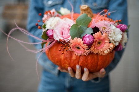 Close-up of a beautiful flower arrangement decorated in a pumpkin for the Halloweenの写真素材