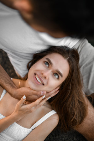 Top view of happy smiling face of woman looking at her fiance leaning over herの写真素材