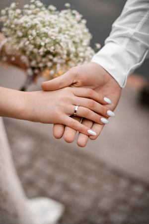 Close up of a brides palm with a wedding ring in her grooms handの写真素材