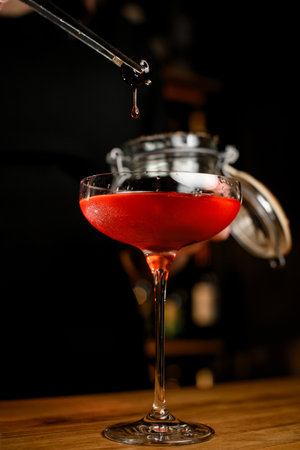 Close-up photo of a glass filled with a red cold drinkの写真素材
