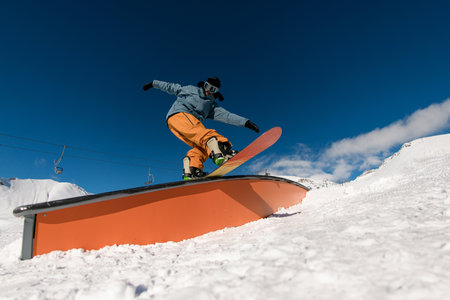 Snowboarder wallride stunts showcase skillful tricks and precise balance.の写真素材