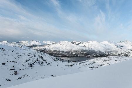 Beautiful view of a mountain massif covered with snow, where a river can be seenの写真素材