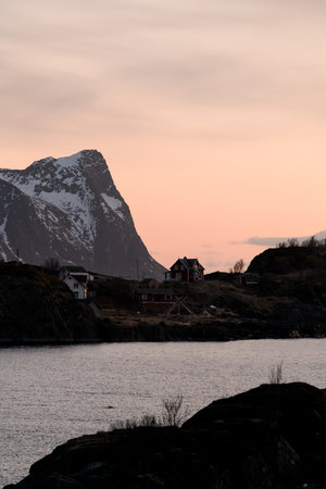 View of the river and several houses on the other bank, which are located near a high mountainの写真素材