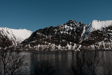 Side view of a high mountain range on the seashoreの写真素材