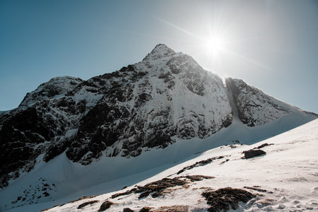 Beautiful landscape in the mountains. A high rocky mountain, covered with snow in placesの写真素材