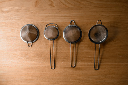 Four fine strainers for straining a cocktail lie in a rowの写真素材
