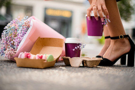 Donuts, coffee, flowers. A combination of indulgence and eleganceの写真素材