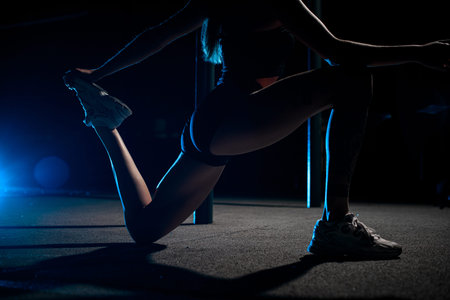 Close-up of the body of an athletic woman doing a toning exercise with one leg on her knee