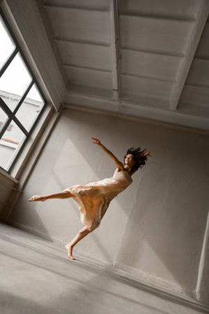 Young slender dancer stands on tiptoe and bent at the kneeの写真素材