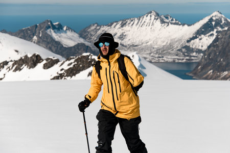 Close-up of skier in a yellow jacket on the snowy slopeの写真素材