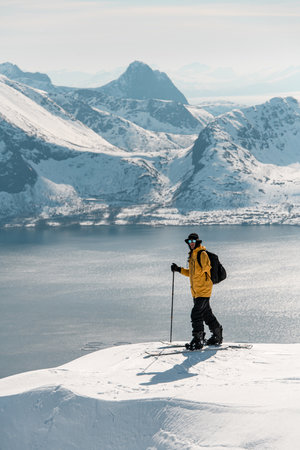 One-armed skier stands on top of a mountain and looking at the cameraの写真素材