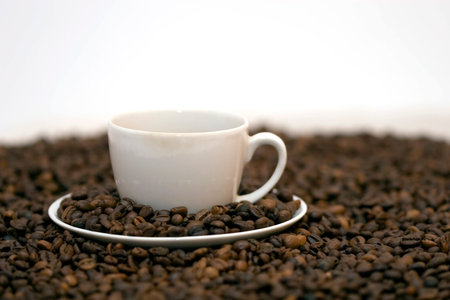 Coffe beans in cup on coffee backgroundの写真素材