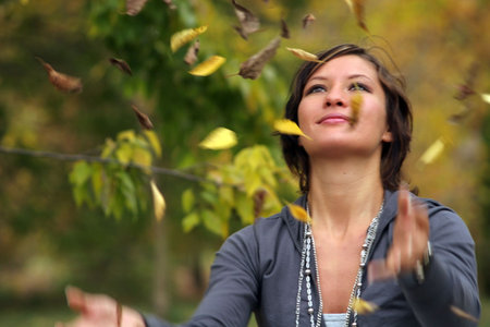 A beauty woman is in the park in  autumn