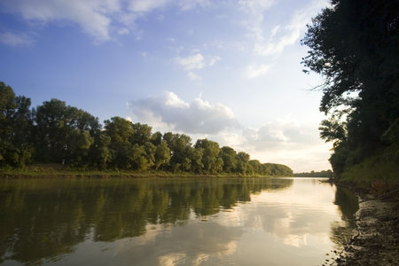 Peaceful scenic view of river and landscape in Summer