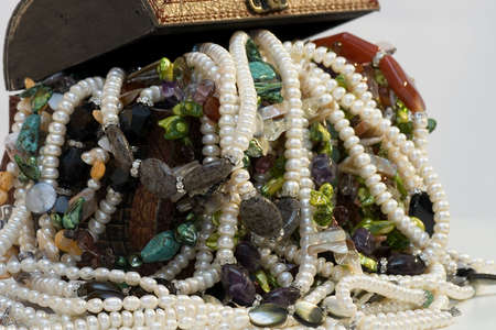 Chest full of jewelry treasures. Isolate on whiteの写真素材