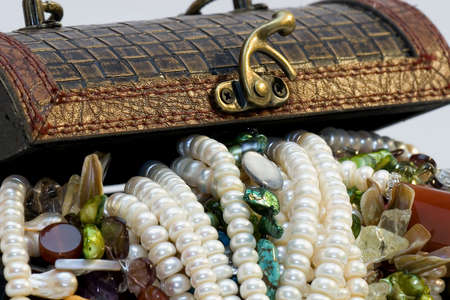 Chest full of jewelry treasures. Isolate on whiteの写真素材