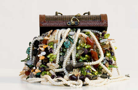 Chest full of jewelry treasures. Isolate on whiteの写真素材