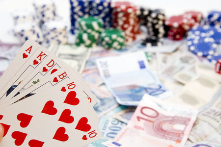  Ace Poker hands - cards have focus with poker chips and money in background.