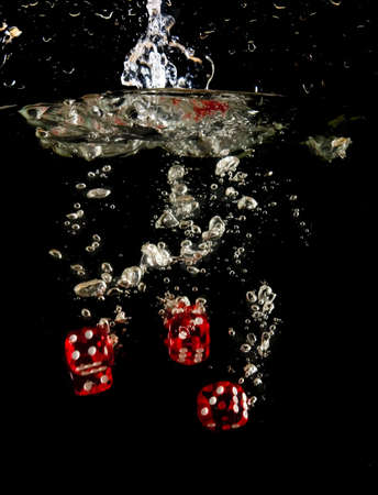 Dice falling into water.の写真素材