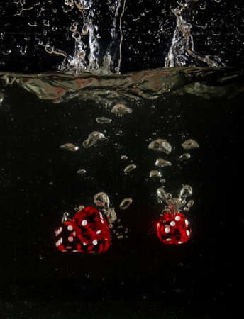 Dice falling into water.の写真素材